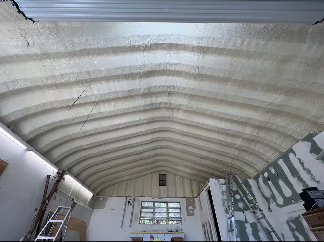 Spray polyurethane foam applied to the underside of a metal roof deck in Town and Country